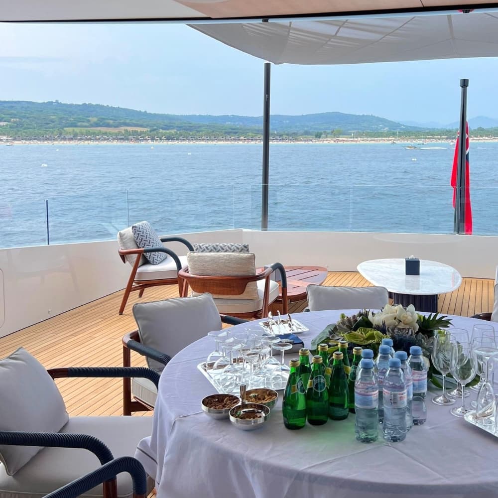 A table laid for guests on the deck of a yacht