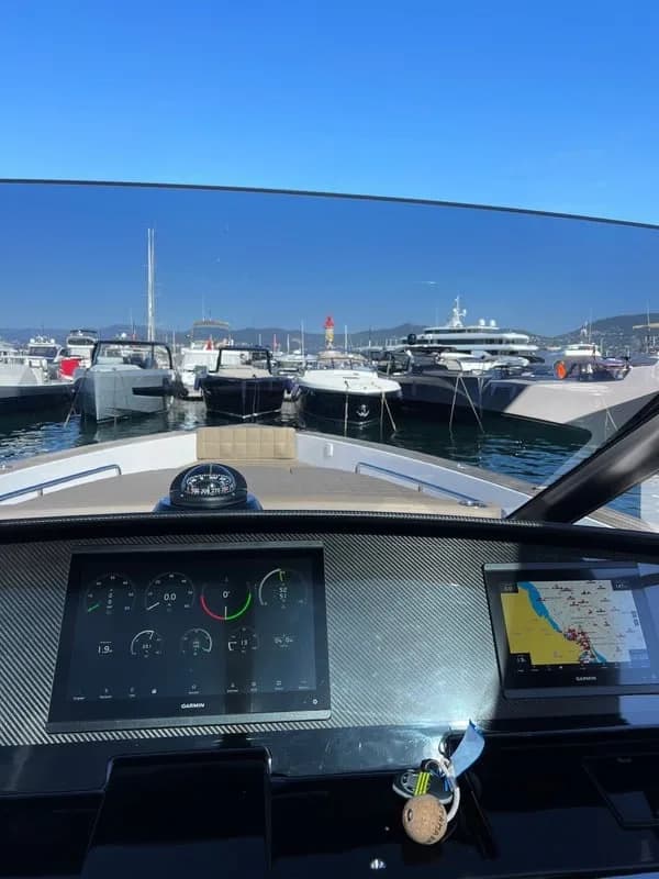 The helm of a yacht, looking out over a marina